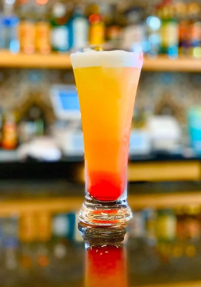 A colorful Máncora signature pisco cocktail at the bar
